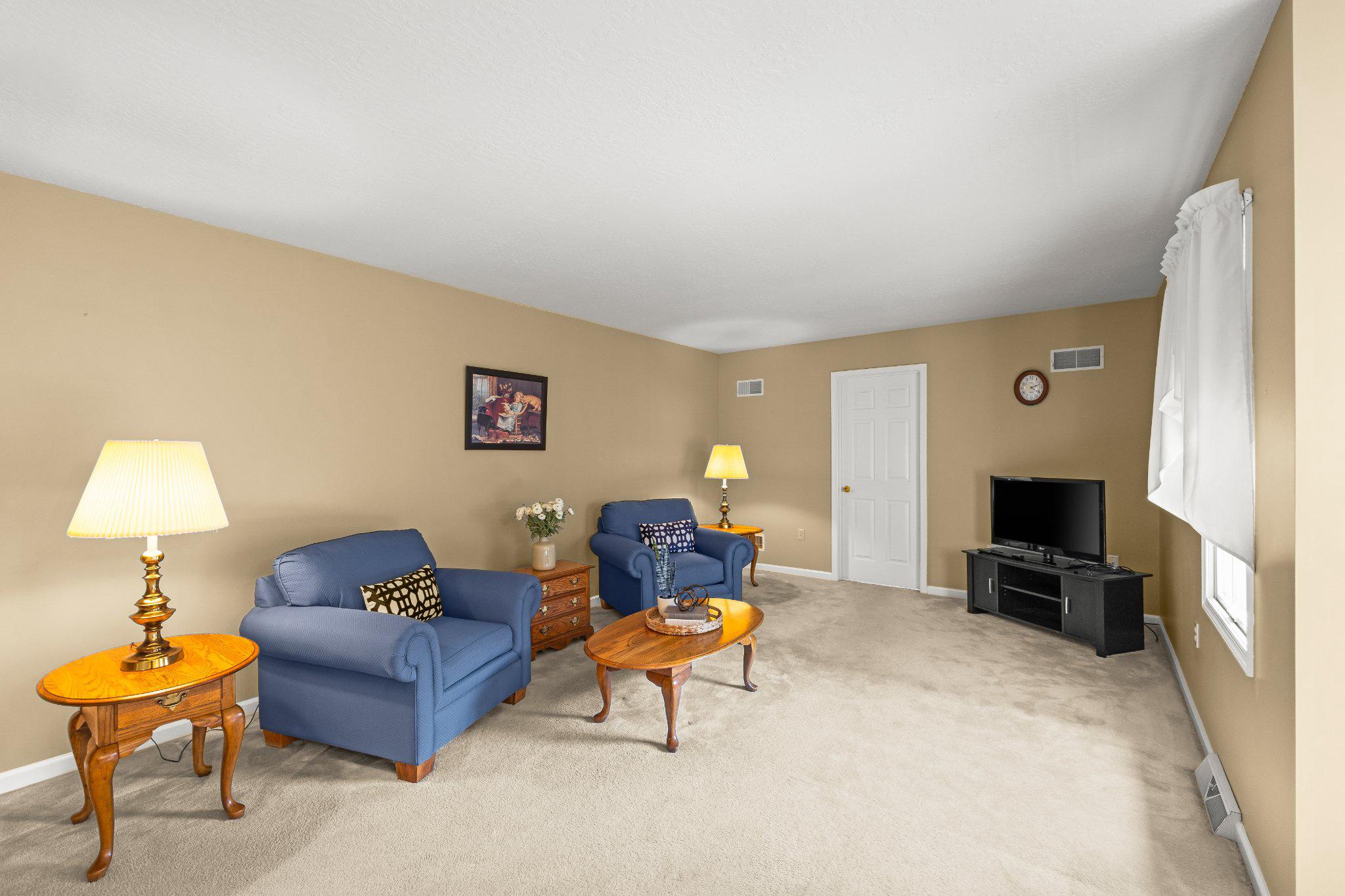 443 Crosswinds Drive Lititz, PA 17543 - Photo 8 of 26 a living room with furniture a flat screen tv and a lamp