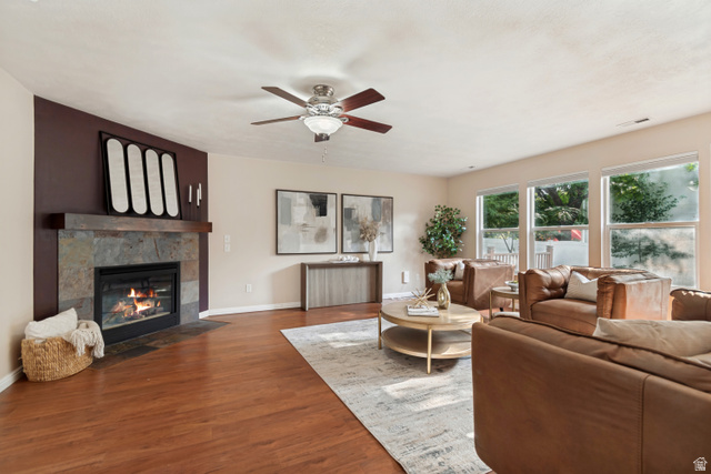 11798 Spiraea Way Draper, UT 84020 - Photo 7 of 21 Living area featuring wood-finish flooring and a stone-clad fireplace with a wood mantel