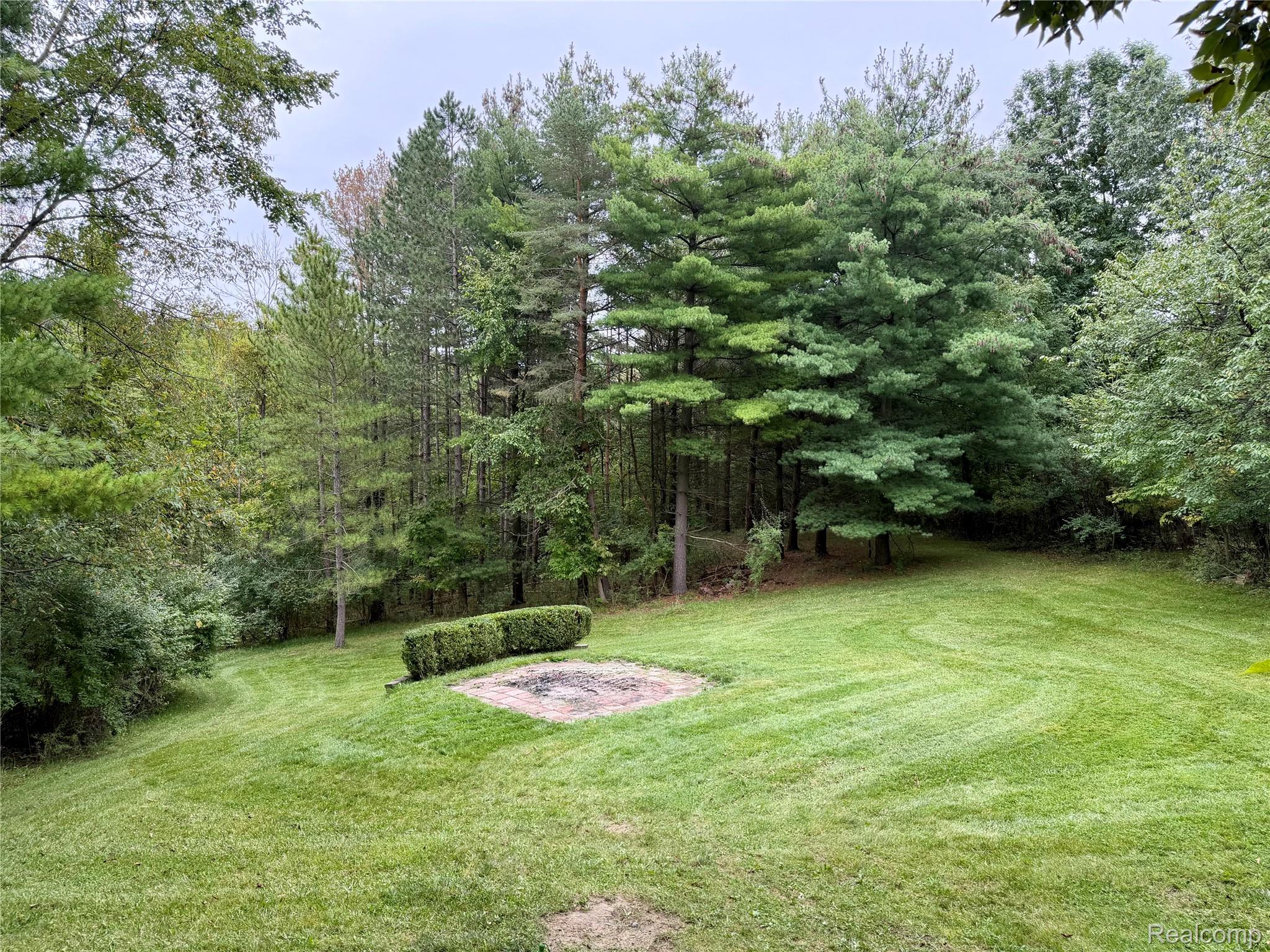 10280 Nimphie Road Fenton, MI 48430 - Photo 27 of 30 Expansive lawn with mature trees and a dedicated fire pit area