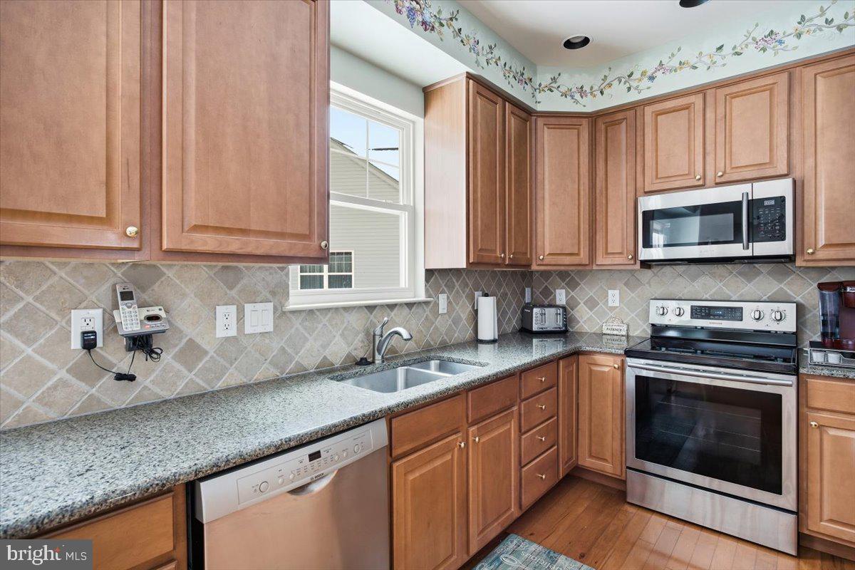 44 Mitchell Court Marlton, NJ 08053 - Photo 11 of 46 a kitchen with stainless steel appliances granite countertop a sink a stove a microwave and cabinets