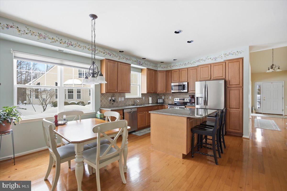 44 Mitchell Court Marlton, NJ 08053 - Photo 12 of 46 a kitchen with stainless steel appliances a dining table chairs and wooden floor