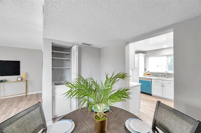 a living room with furniture potted plant and a bathroom
