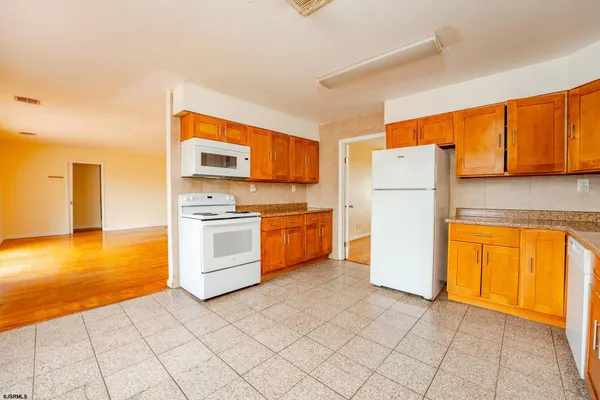 a kitchen with a refrigerator sink stove and cabinets