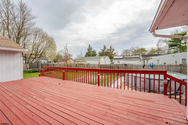 a view of balcony with wooden floor and fence