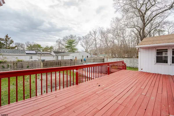 a balcony with wooden floor and city view