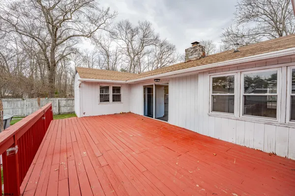 a view of house with backyard and deck