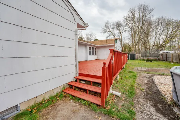 a backyard of a house with wooden floor and fence
