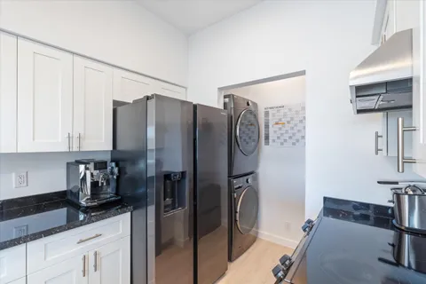 a kitchen with stainless steel appliances granite countertop a refrigerator and a sink