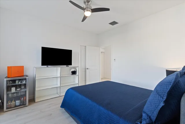 a bedroom with a bed and a flat screen tv