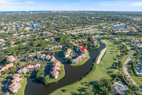 an aerial view of a house with a lot of trees all around
