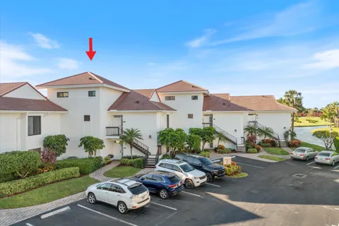 a front view of a house with a yard and outdoor seating