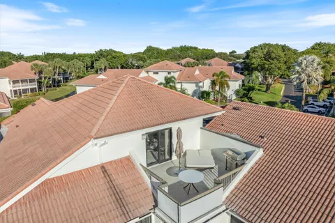 a view of house with pool and outdoor seating