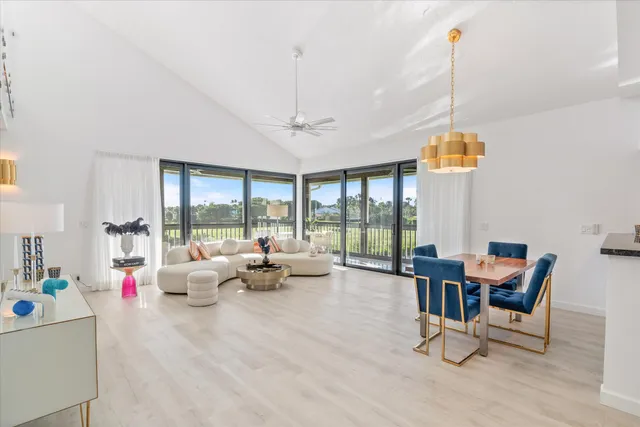 a living room with furniture and a floor to ceiling window