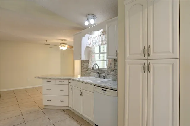 a bathroom with a granite countertop sink a mirror and a vanity