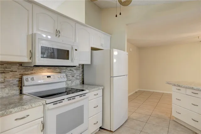a kitchen with appliances a sink and cabinets