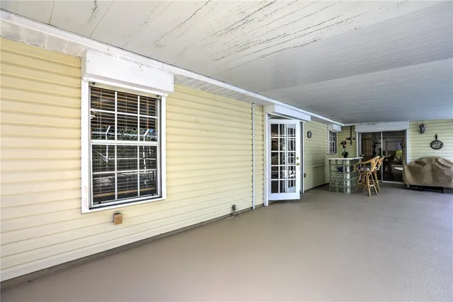 a view of an empty room with furniture and a window