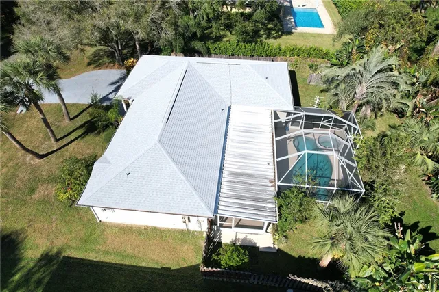 an aerial view of a house with a yard