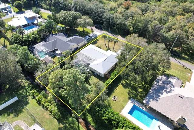 an aerial view of house with a yard