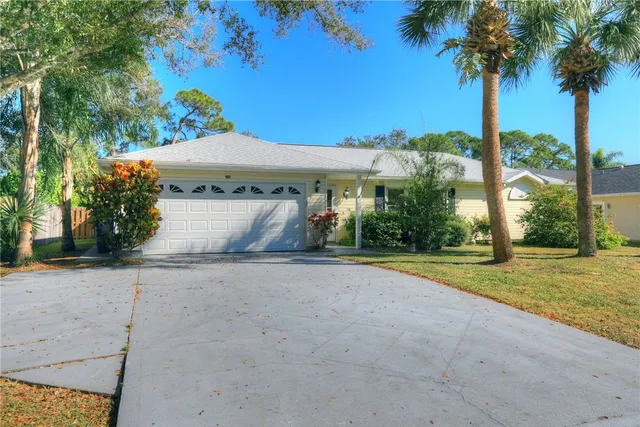 a view of a house with palm trees