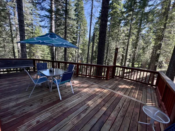a view of a wooden deck with furniture