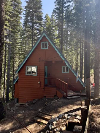 a view of a small house with a yard