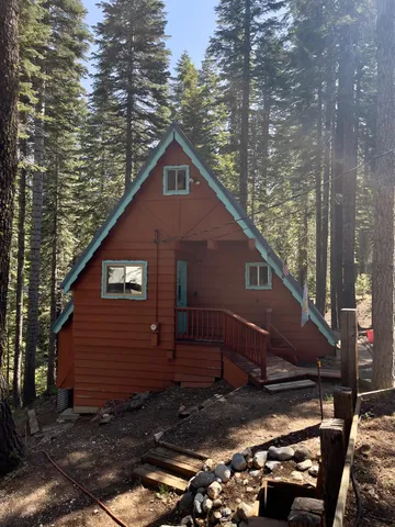 a view of a small house with a yard