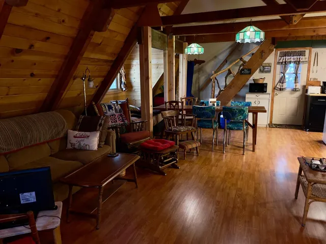 a living room with lots of furniture and wooden floors