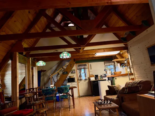 a view of a livingroom with furniture wooden floor and windows
