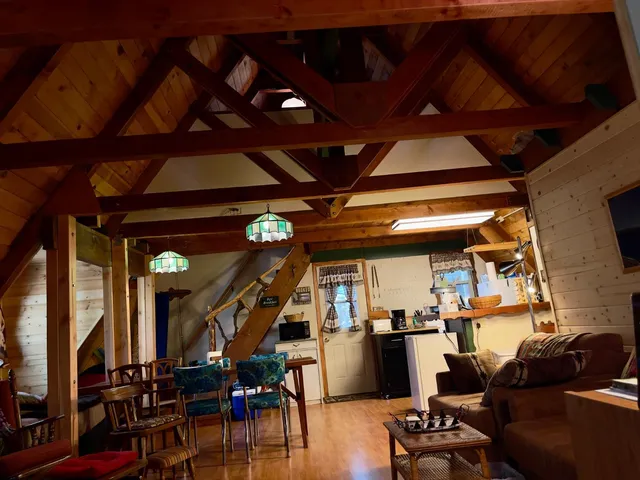 a view of a livingroom with furniture wooden floor and windows