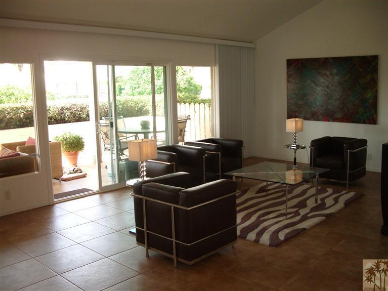 1717 East Sonora Road Palm Springs, CA 92264 - Photo 2 of 25 a living room with furniture a flat screen tv and a floor to ceiling window