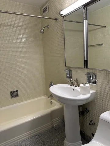 a bathroom with a sink a mirror and a bathtub