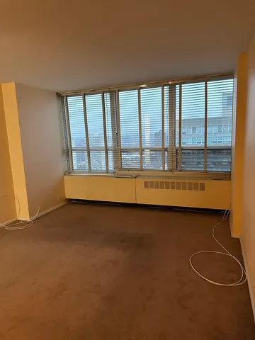 an empty room with floor to ceiling windows