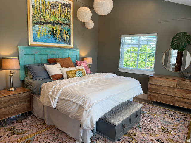 776 Canyon Road Hyde Park, UT 84318 - Photo 32 of 57 Vaulted ceilings and a large window illuminate this bedroom, featuring a unique teal headboard