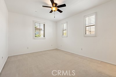 20332 Paseo Meriana Porter Ranch, CA 91326 - Photo 16 of 19 an empty room with windows and fan