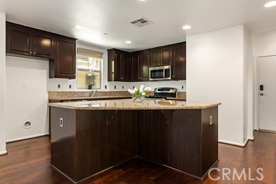 20332 Paseo Meriana Porter Ranch, CA 91326 - Photo 3 of 19 a kitchen with granite countertop a sink cabinets and stainless steel appliances