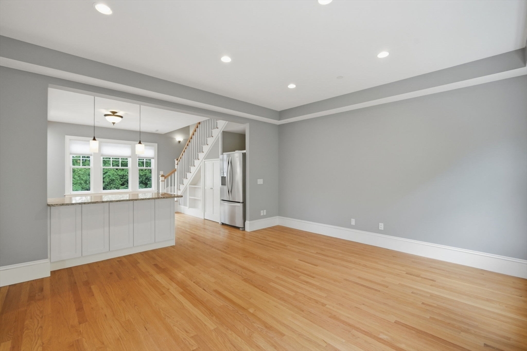 151 Amity Street, Unit 2 Amherst, MA 01002 - Photo 14 of 42 wooden floor in an empty room with a window