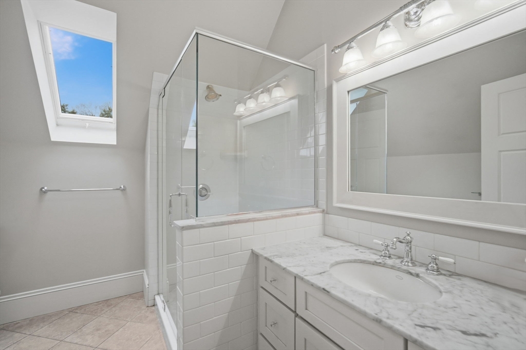 151 Amity Street, Unit 2 Amherst, MA 01002 - Photo 27 of 42 a bathroom with a granite countertop sink mirror and double