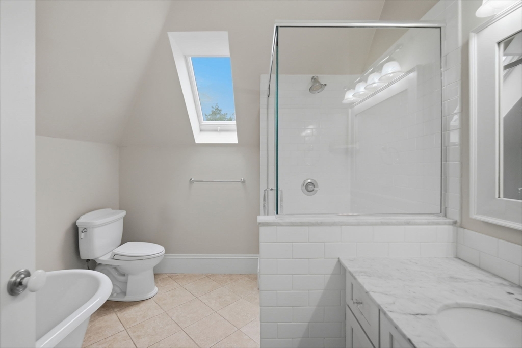 151 Amity Street, Unit 2 Amherst, MA 01002 - Photo 28 of 42 a bathroom with a granite countertop sink a toilet and shower