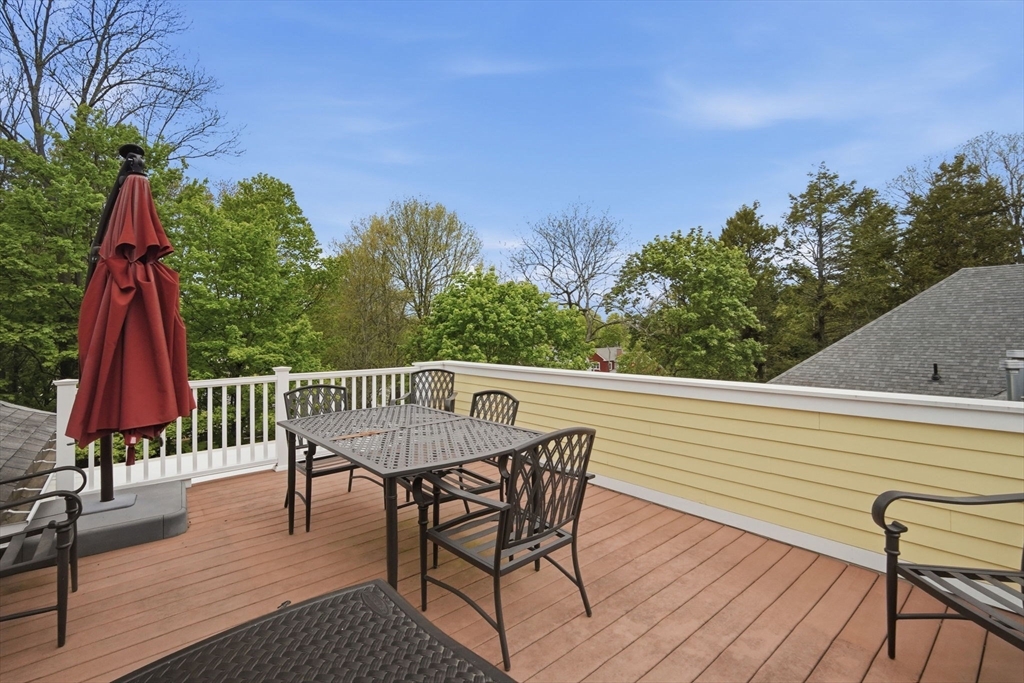 151 Amity Street, Unit 2 Amherst, MA 01002 - Photo 32 of 42 a view of a chairs and table on the deck