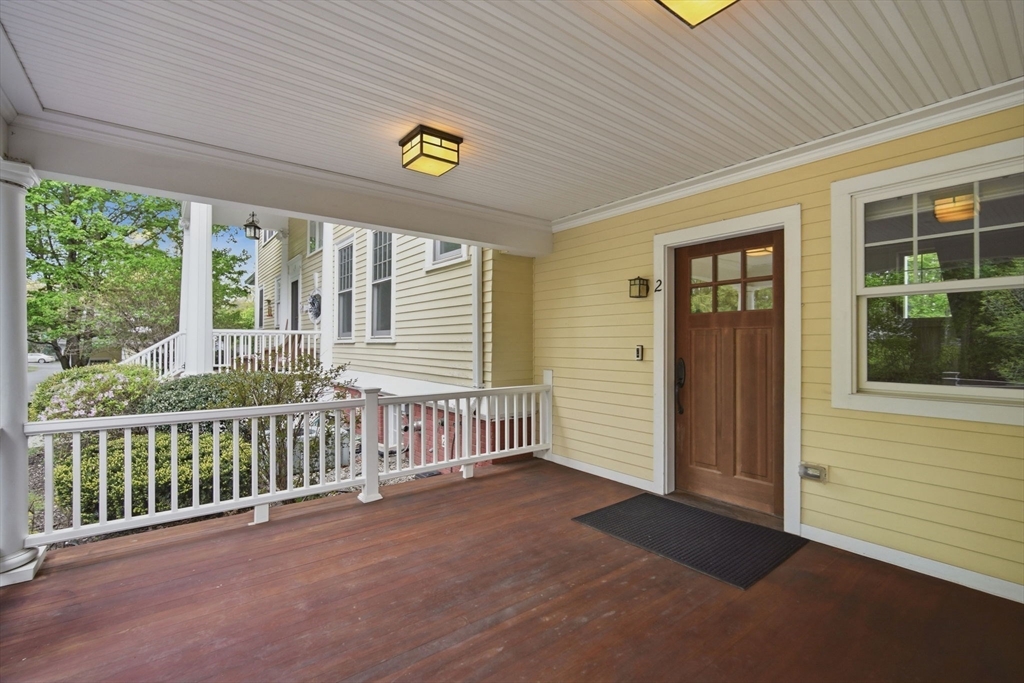 151 Amity Street, Unit 2 Amherst, MA 01002 - Photo 4 of 42 a view of a porch with a table and chairs