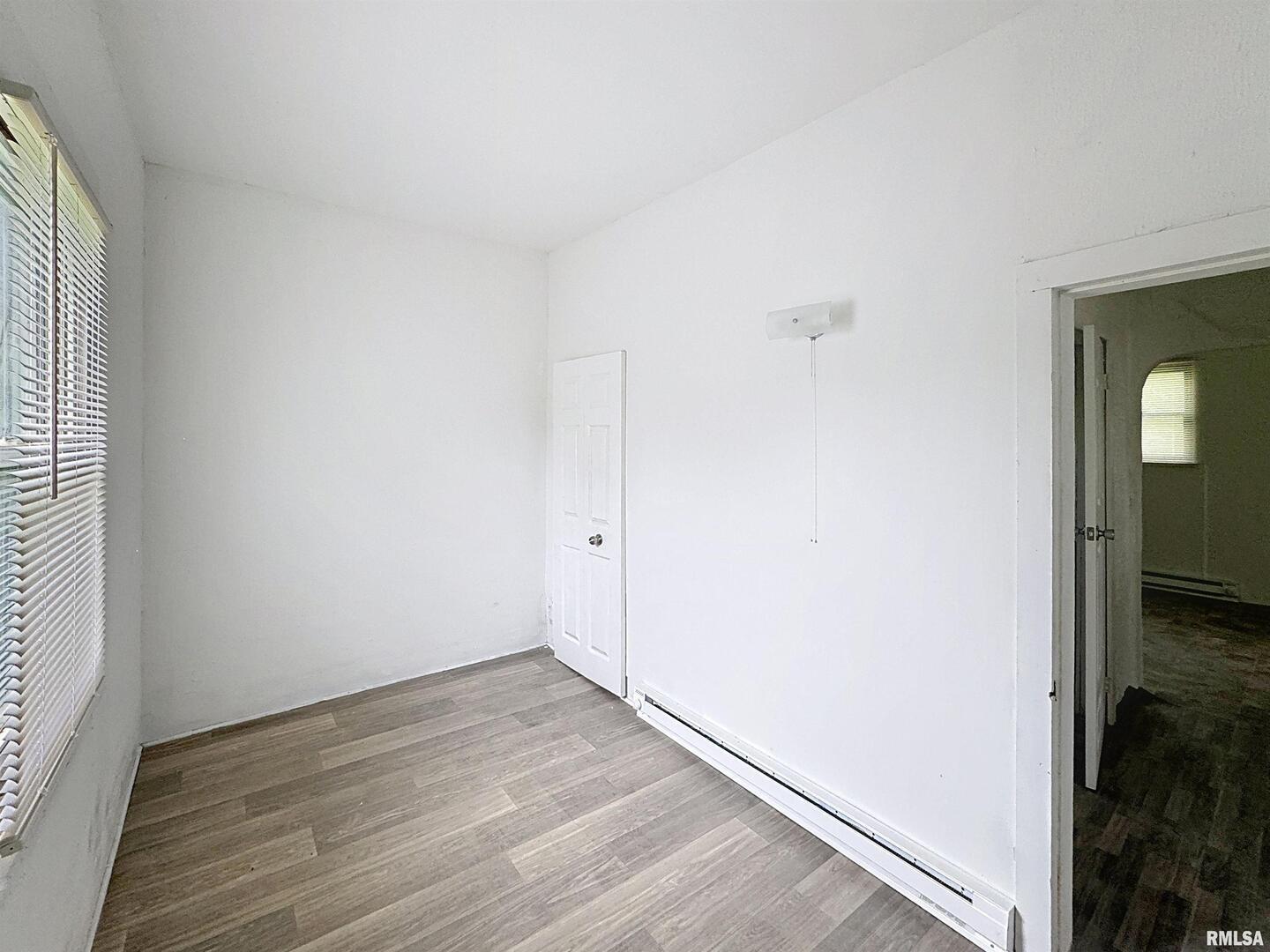 204 Main Avenue Matherville, IL 61263 - Photo 15 of 27 an empty room with wooden floor and mirror