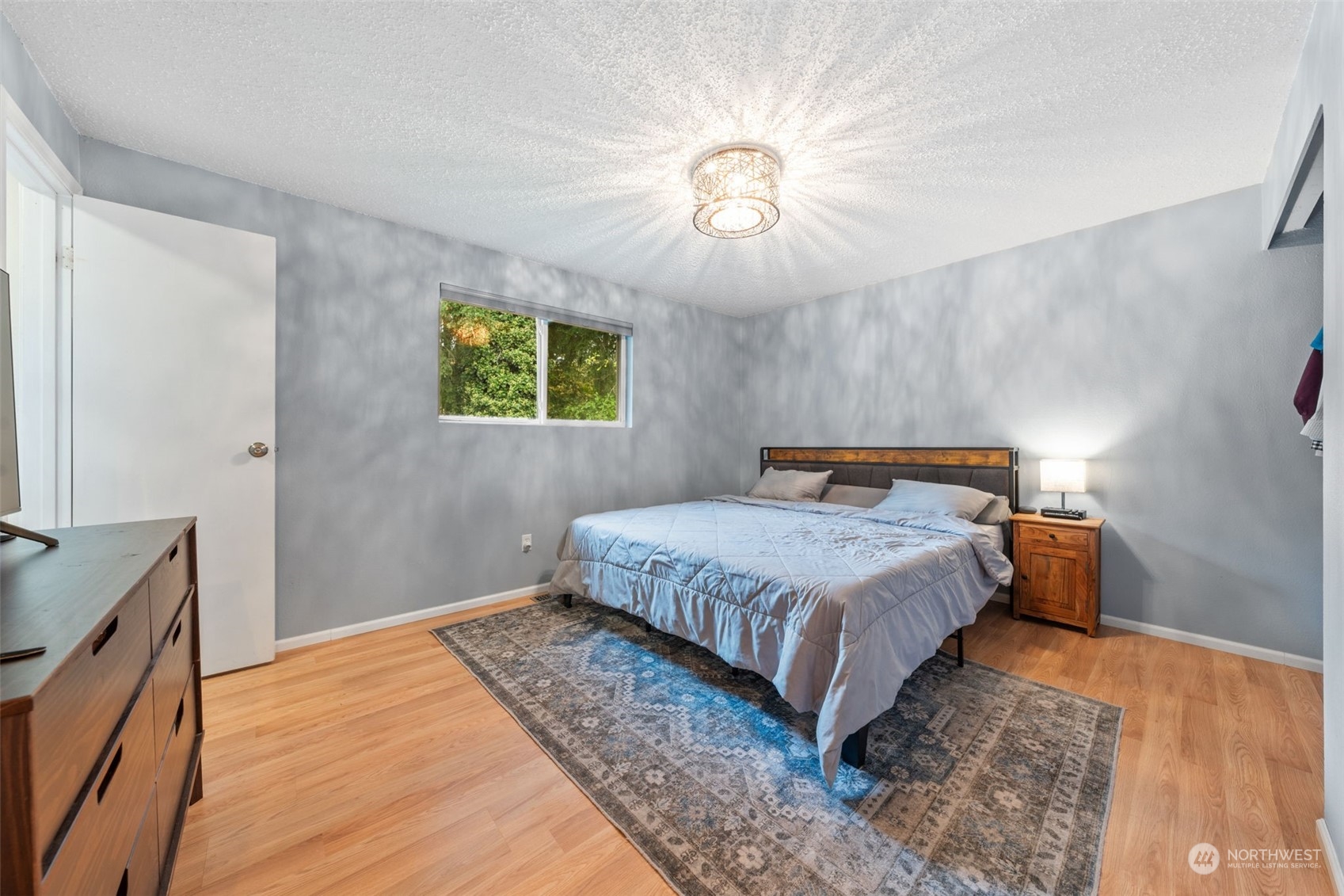 2746 Northeast 24th Street Renton, WA 98056 - Photo 15 of 20 a bedroom with a bed and a chandelier