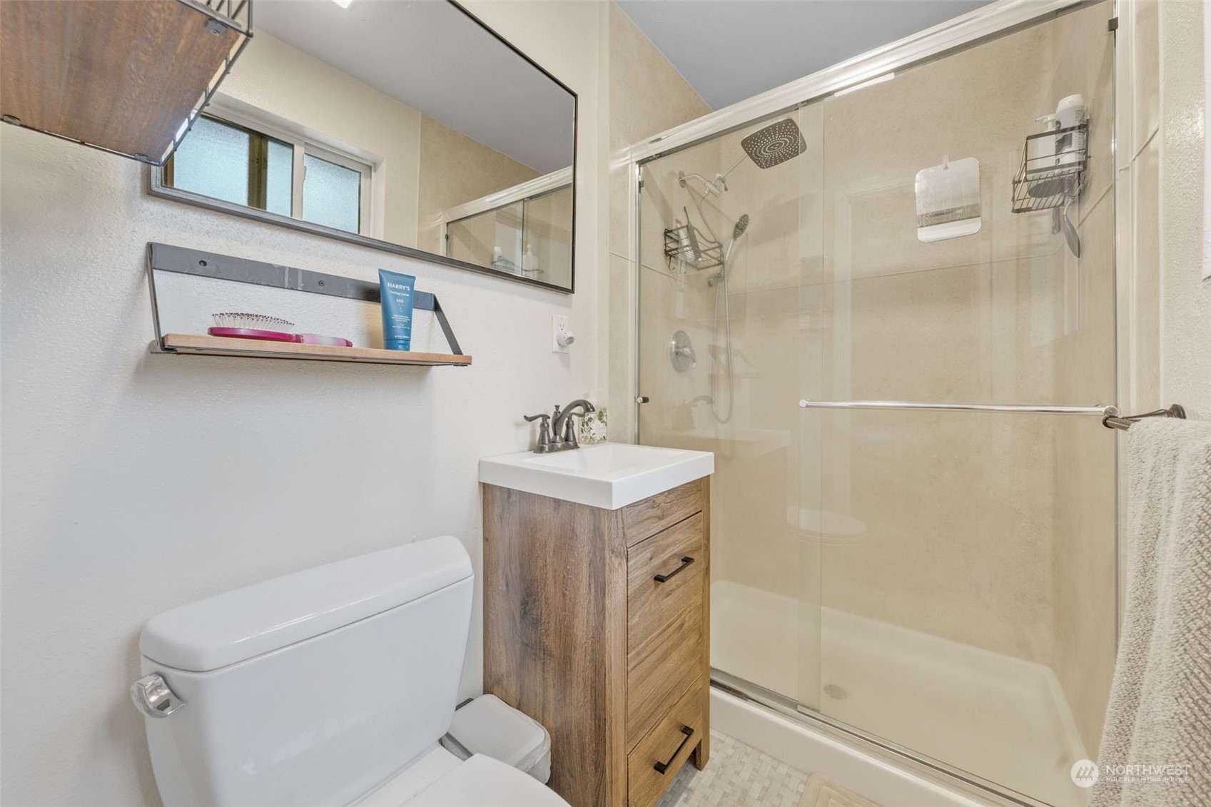 2746 Northeast 24th Street Renton, WA 98056 - Photo 16 of 20 a bathroom with a sink a mirror and a shower