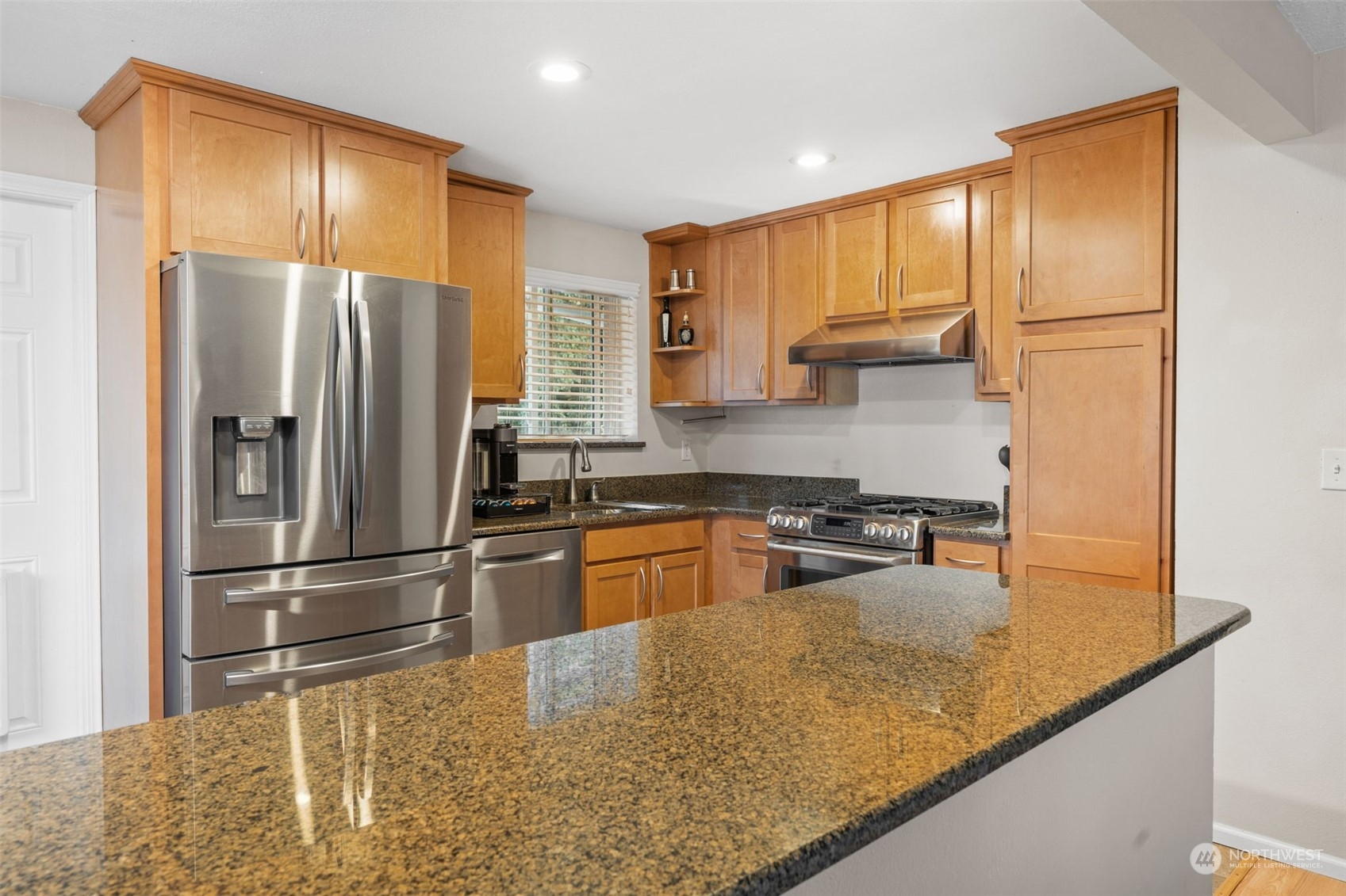 2746 Northeast 24th Street Renton, WA 98056 - Photo 7 of 20 a kitchen with stainless steel appliances granite countertop a refrigerator a stove and a sink with wooden floor