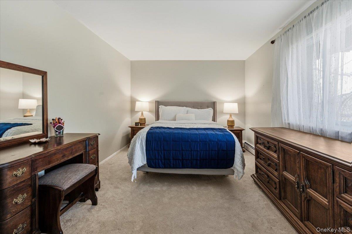 9 North James Street, Unit B Peekskill, NY 10566 - Photo 11 of 22 Large Primary Bedroom featuring light colored carpet and baseboard heating and closet