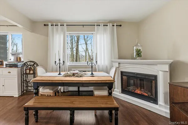 a view of a a dining room with furniture window and wooden floor