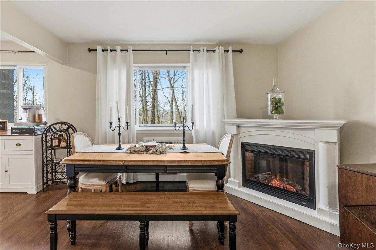 9 North James Street, Unit B Peekskill, NY 10566 - Photo 4 of 22 Dining area with fireplace, dark wood finished floors, and plenty of natural light