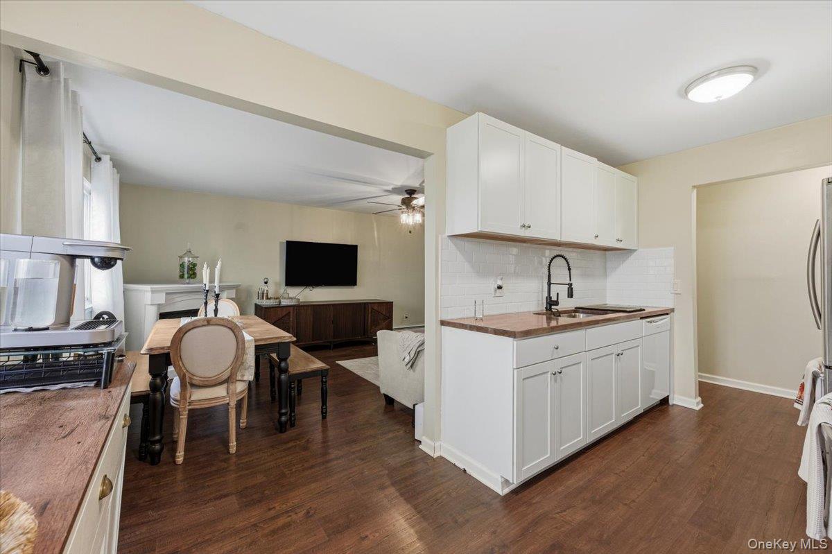 9 North James Street, Unit B Peekskill, NY 10566 - Photo 22 of 22 Kitchen with white cabinetry, dark wood-style floors, tasteful backsplash, open floor plan, and a ceiling fan