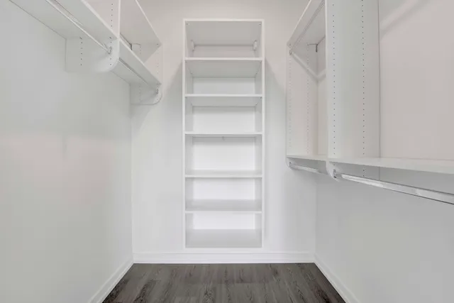 a view of walk in closet with empty racks