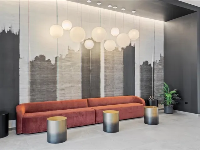 a living room with furniture a chandelier and a large window